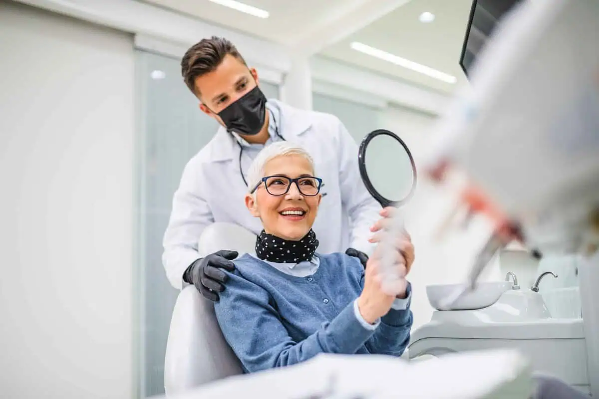 Patient with missing teeth learning the signs you need dental implants in Kansas City