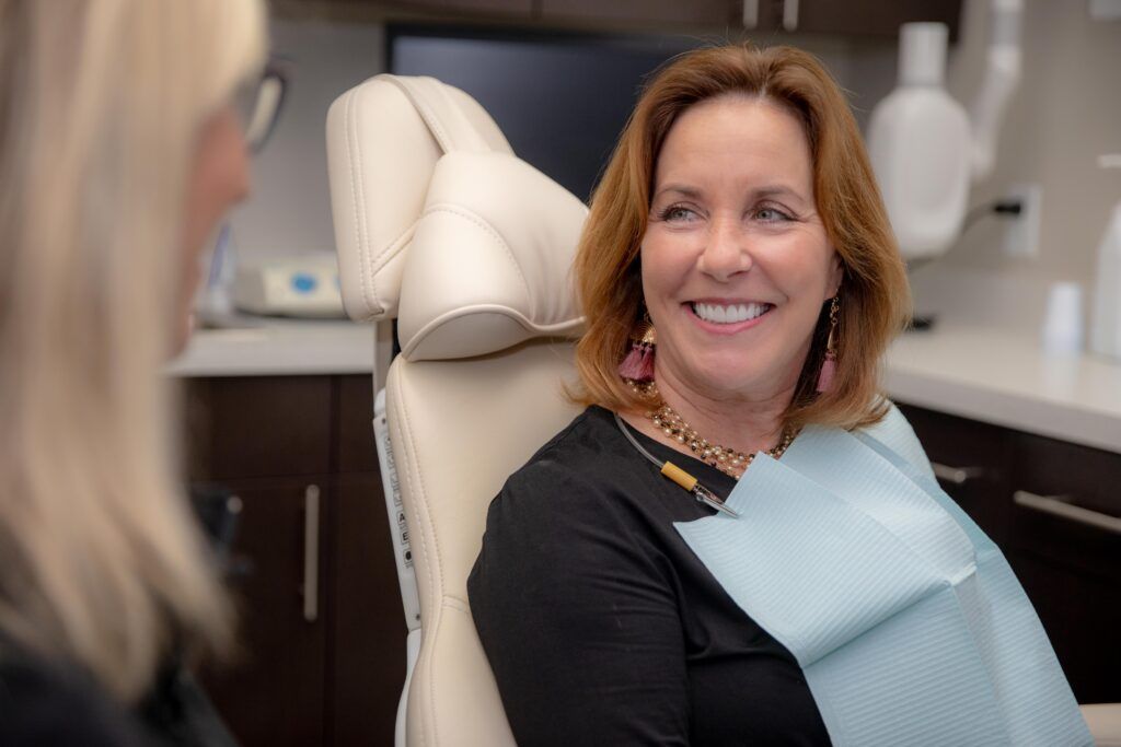 woman sitting in dentist chair for dental implants
